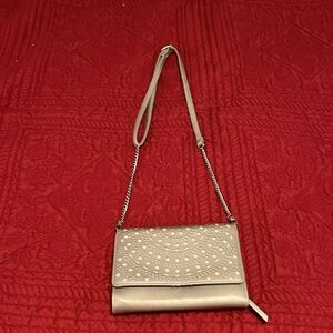 A Crossbody max studio bag the color is a creamish tan